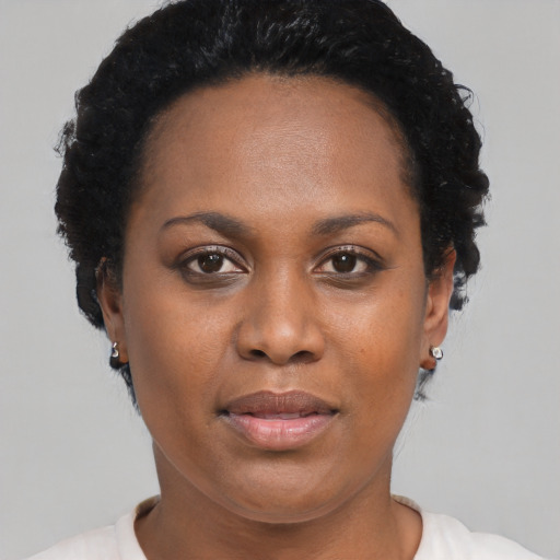 Joyful black adult female with short  black hair and brown eyes