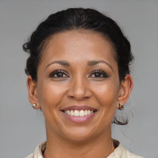 Joyful black adult female with short  brown hair and brown eyes