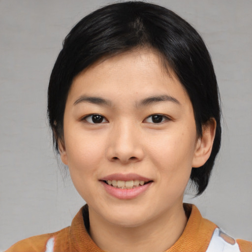 Joyful asian young-adult female with medium  black hair and brown eyes