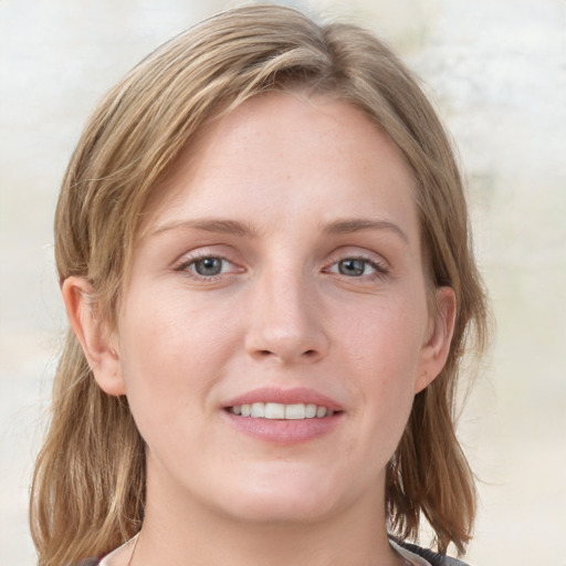 Joyful white young-adult female with medium  brown hair and blue eyes