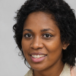 Joyful black young-adult female with long  brown hair and brown eyes