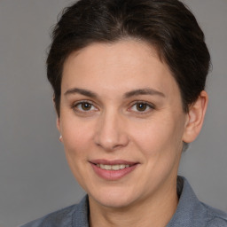 Joyful white young-adult female with medium  brown hair and brown eyes