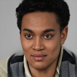 Joyful latino young-adult male with short  brown hair and brown eyes