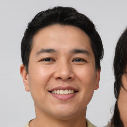 Joyful white young-adult male with short  black hair and brown eyes