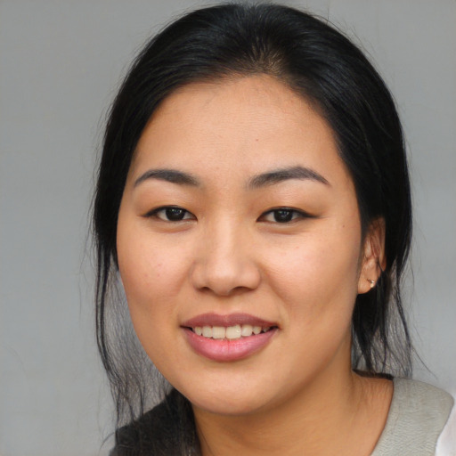 Joyful asian young-adult female with medium  black hair and brown eyes