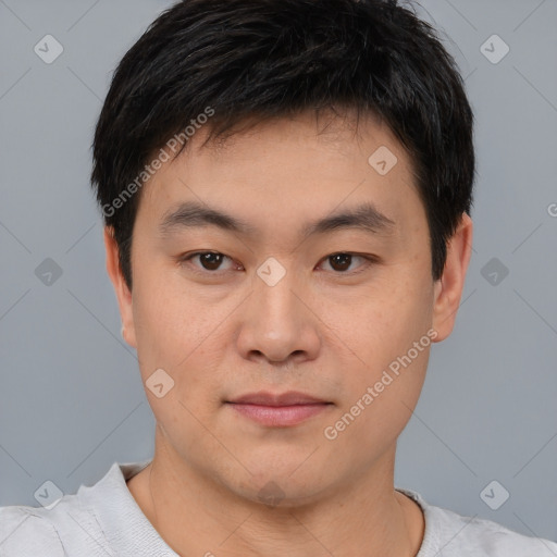 Joyful asian young-adult male with short  brown hair and brown eyes