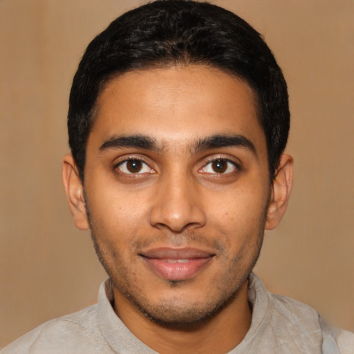 Joyful latino young-adult male with short  black hair and brown eyes