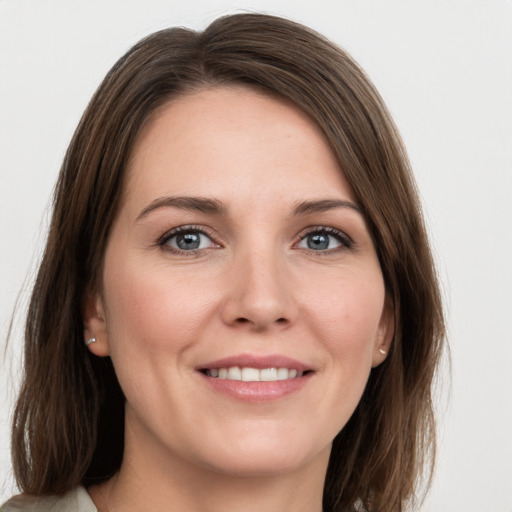 Joyful white young-adult female with medium  brown hair and grey eyes