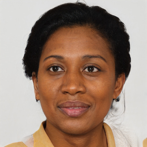 Joyful black adult female with short  brown hair and brown eyes