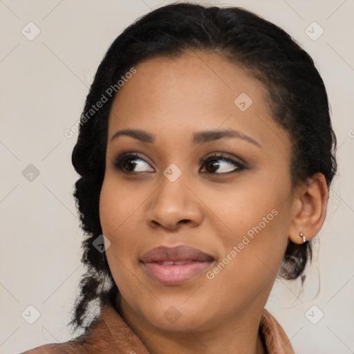 Joyful black young-adult female with medium  brown hair and brown eyes