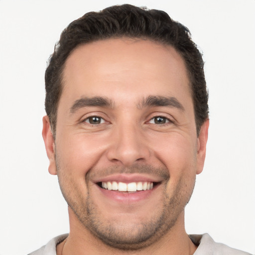 Joyful white young-adult male with short  brown hair and brown eyes