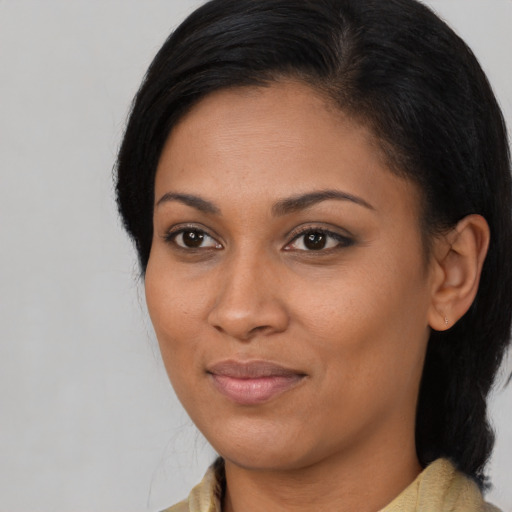 Joyful latino young-adult female with medium  black hair and brown eyes