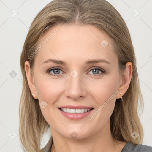 Joyful white young-adult female with long  brown hair and blue eyes