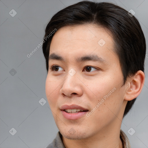 Joyful asian young-adult male with short  brown hair and brown eyes