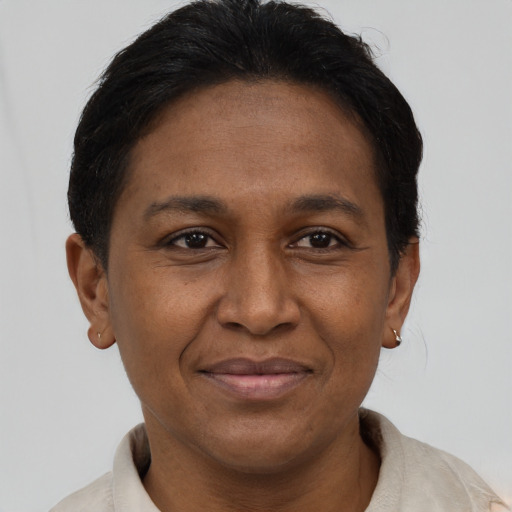 Joyful latino adult female with short  brown hair and brown eyes