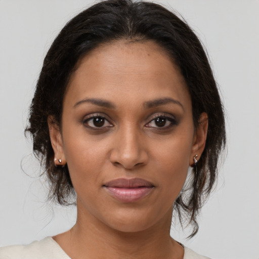 Joyful black young-adult female with medium  brown hair and brown eyes