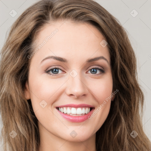 Joyful white young-adult female with long  brown hair and green eyes