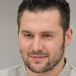 Joyful white adult male with short  brown hair and brown eyes