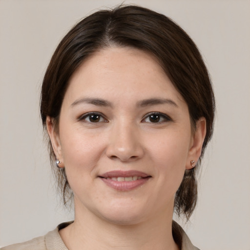 Joyful white young-adult female with medium  brown hair and brown eyes