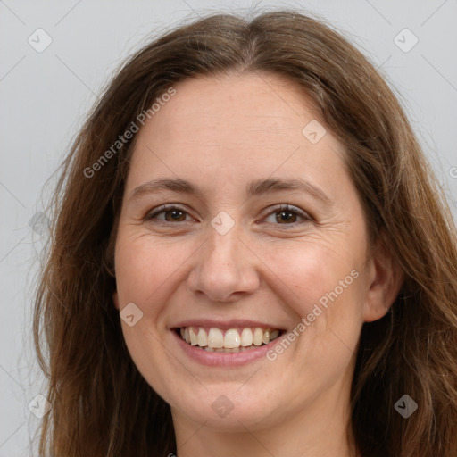 Joyful white adult female with long  brown hair and brown eyes