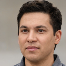 Joyful white young-adult male with short  black hair and brown eyes