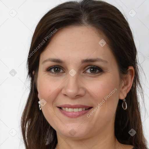 Joyful white adult female with long  brown hair and grey eyes