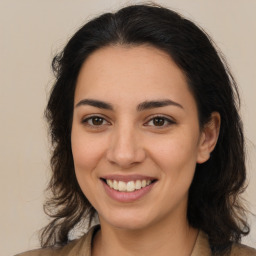 Joyful latino young-adult female with long  brown hair and brown eyes