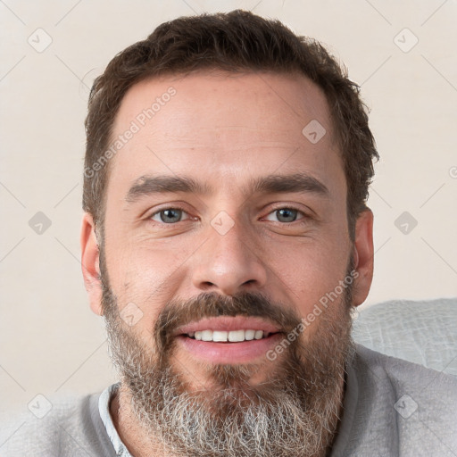 Joyful white adult male with short  brown hair and grey eyes