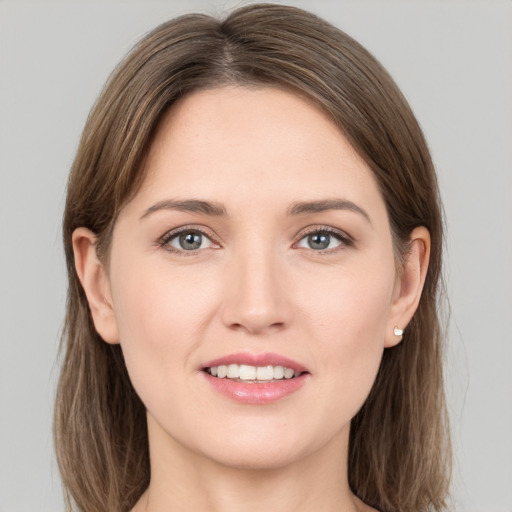 Joyful white young-adult female with long  brown hair and grey eyes