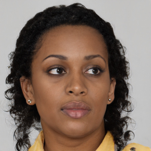 Neutral black young-adult female with long  brown hair and brown eyes