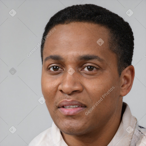 Joyful black young-adult male with short  black hair and brown eyes