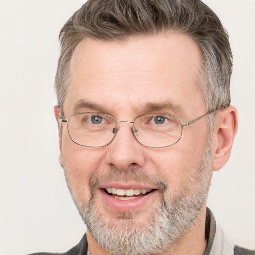 Joyful white middle-aged male with short  brown hair and grey eyes