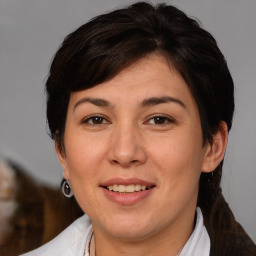 Joyful white adult female with medium  brown hair and brown eyes