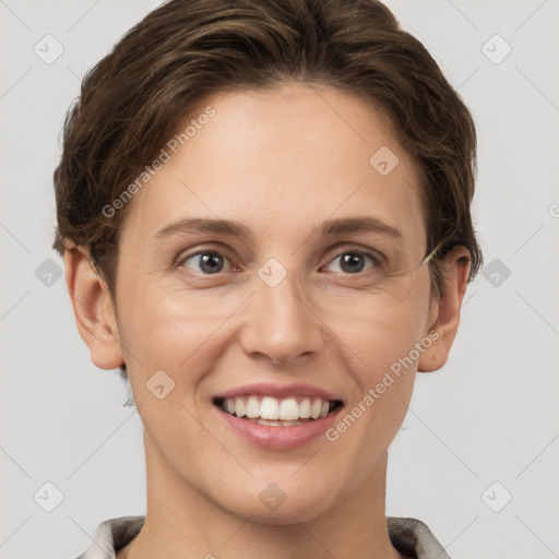 Joyful white young-adult female with short  brown hair and grey eyes