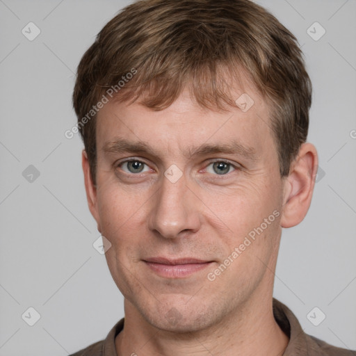 Joyful white adult male with short  brown hair and grey eyes