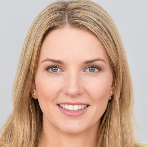 Joyful white young-adult female with long  brown hair and green eyes