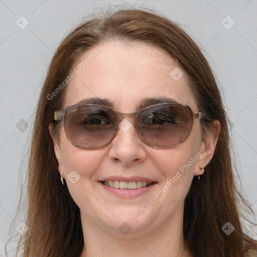 Joyful white adult female with long  brown hair and brown eyes