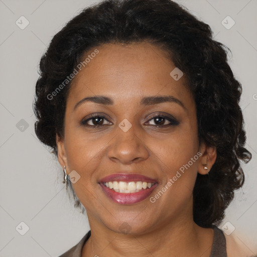 Joyful black adult female with medium  brown hair and brown eyes