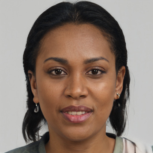 Joyful black young-adult female with medium  brown hair and brown eyes