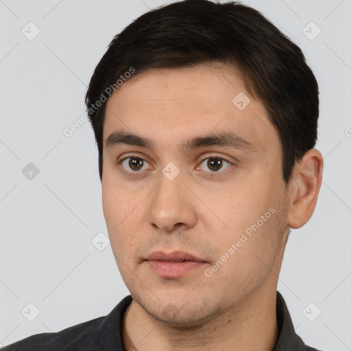 Neutral white young-adult male with short  black hair and brown eyes