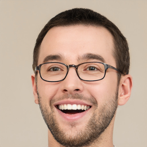 Joyful white young-adult male with short  brown hair and green eyes