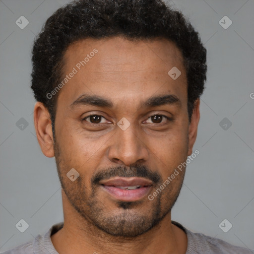 Joyful latino young-adult male with short  brown hair and brown eyes