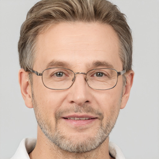 Joyful white middle-aged male with short  brown hair and brown eyes