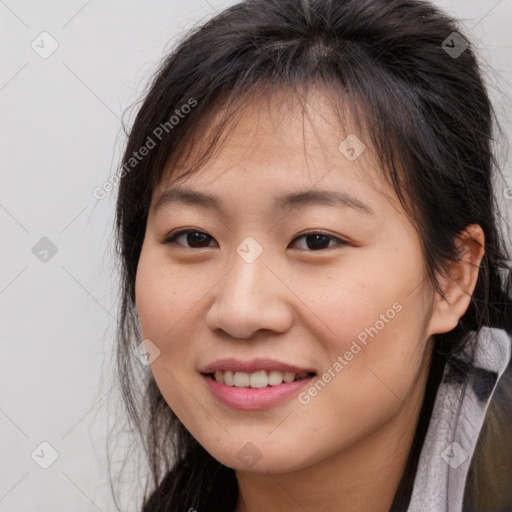 Joyful asian young-adult female with long  brown hair and brown eyes