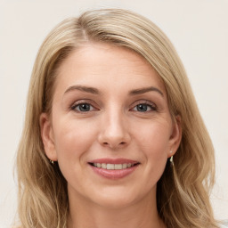 Joyful white young-adult female with long  brown hair and blue eyes