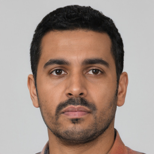 Neutral latino young-adult male with short  black hair and brown eyes