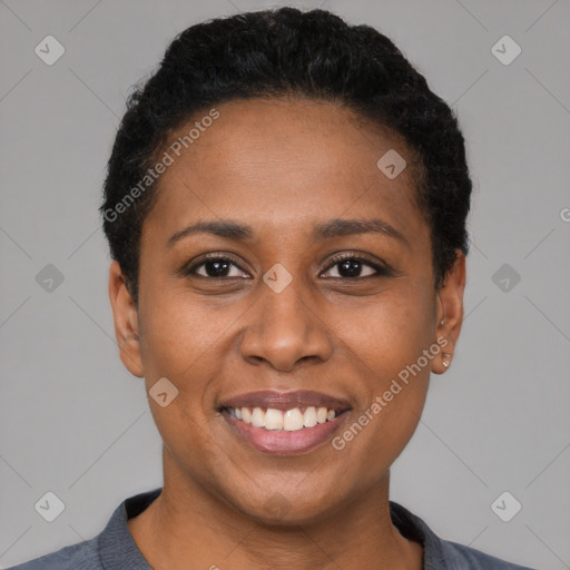 Joyful black young-adult female with short  black hair and brown eyes