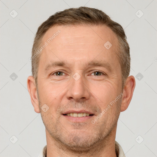 Joyful white adult male with short  brown hair and brown eyes