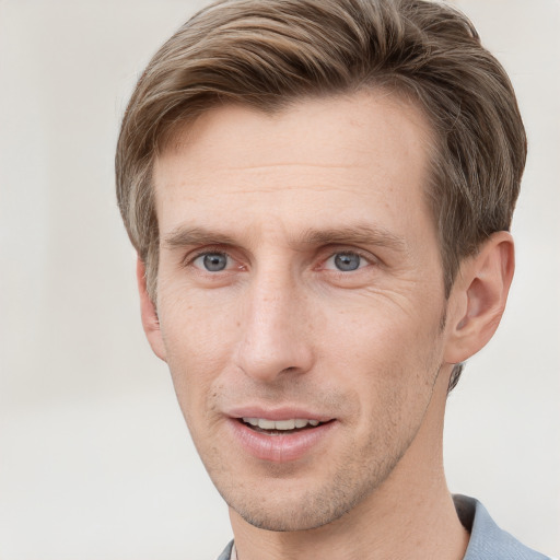 Joyful white adult male with short  brown hair and grey eyes