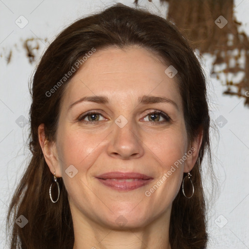 Joyful white adult female with long  brown hair and grey eyes